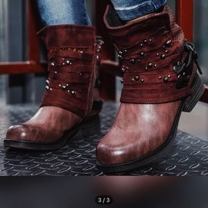 Women’s burgundy motorcycle boots with embellished straps.